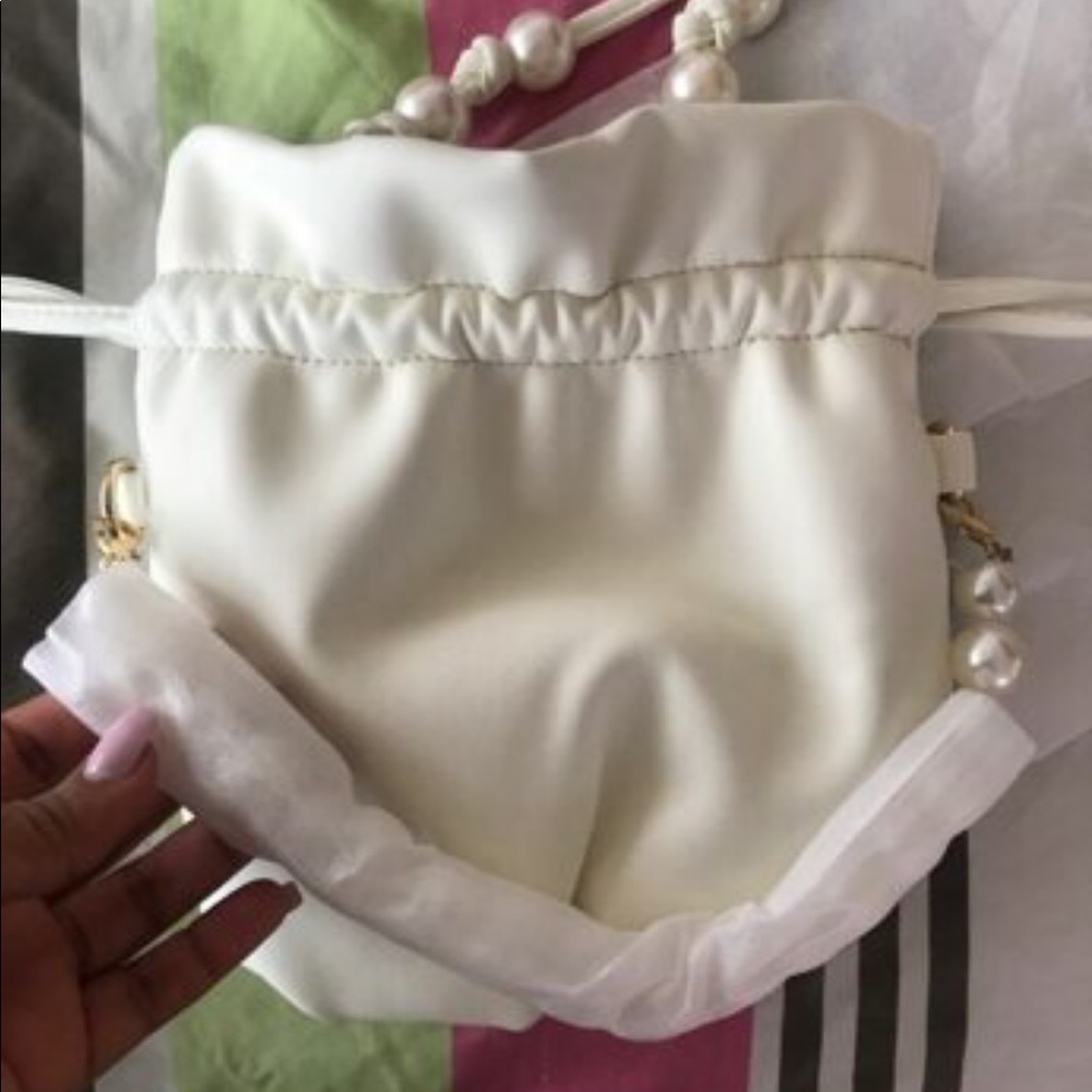 A faux pearl bucket purse